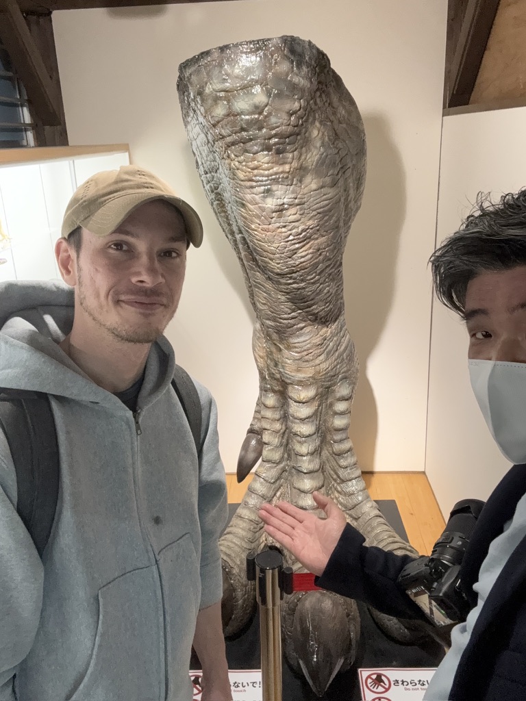 Visitor photographing Evangelion and Ultraman figures at Kaiyodo Hobby Museum Shimanto