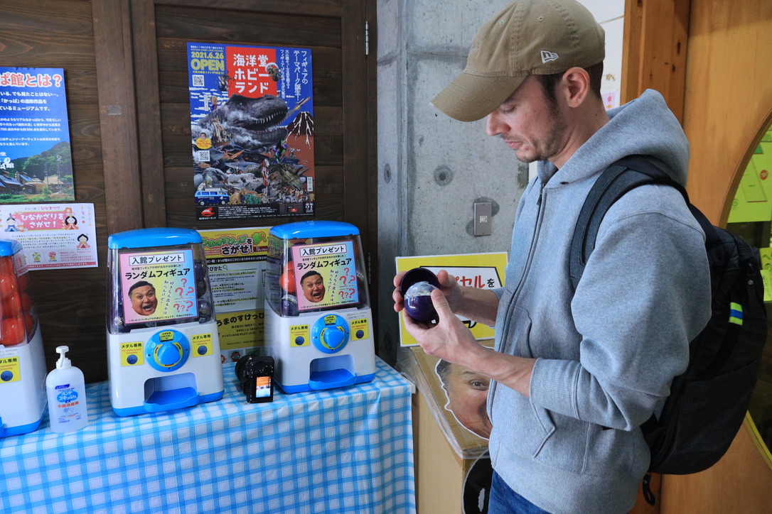 Godzilla figure display with retro robot battle backdrop painting at Kaiyodo Hobby Museum Shimanto