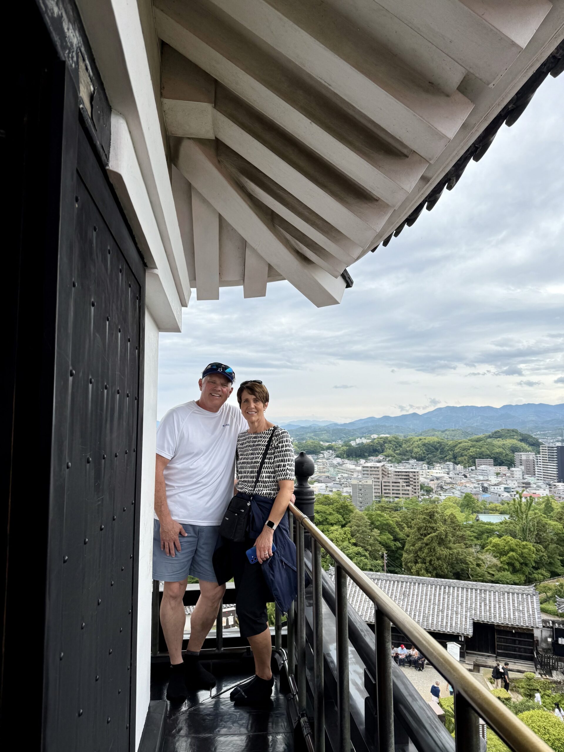 Tour guests enjoying the sweeping panoramic view of Kochi city from the castle keep balcony