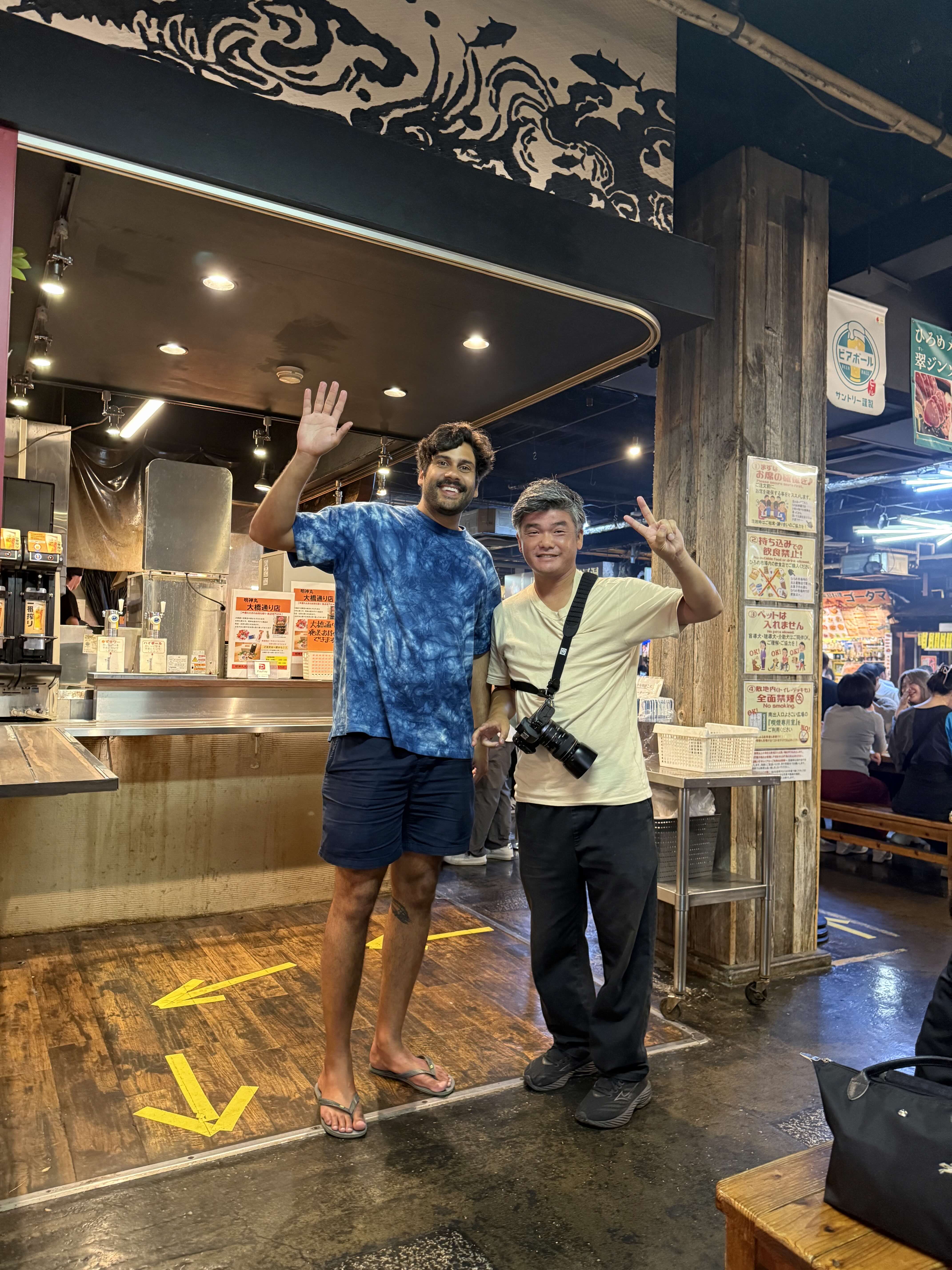 Hiroshi with guest at local market