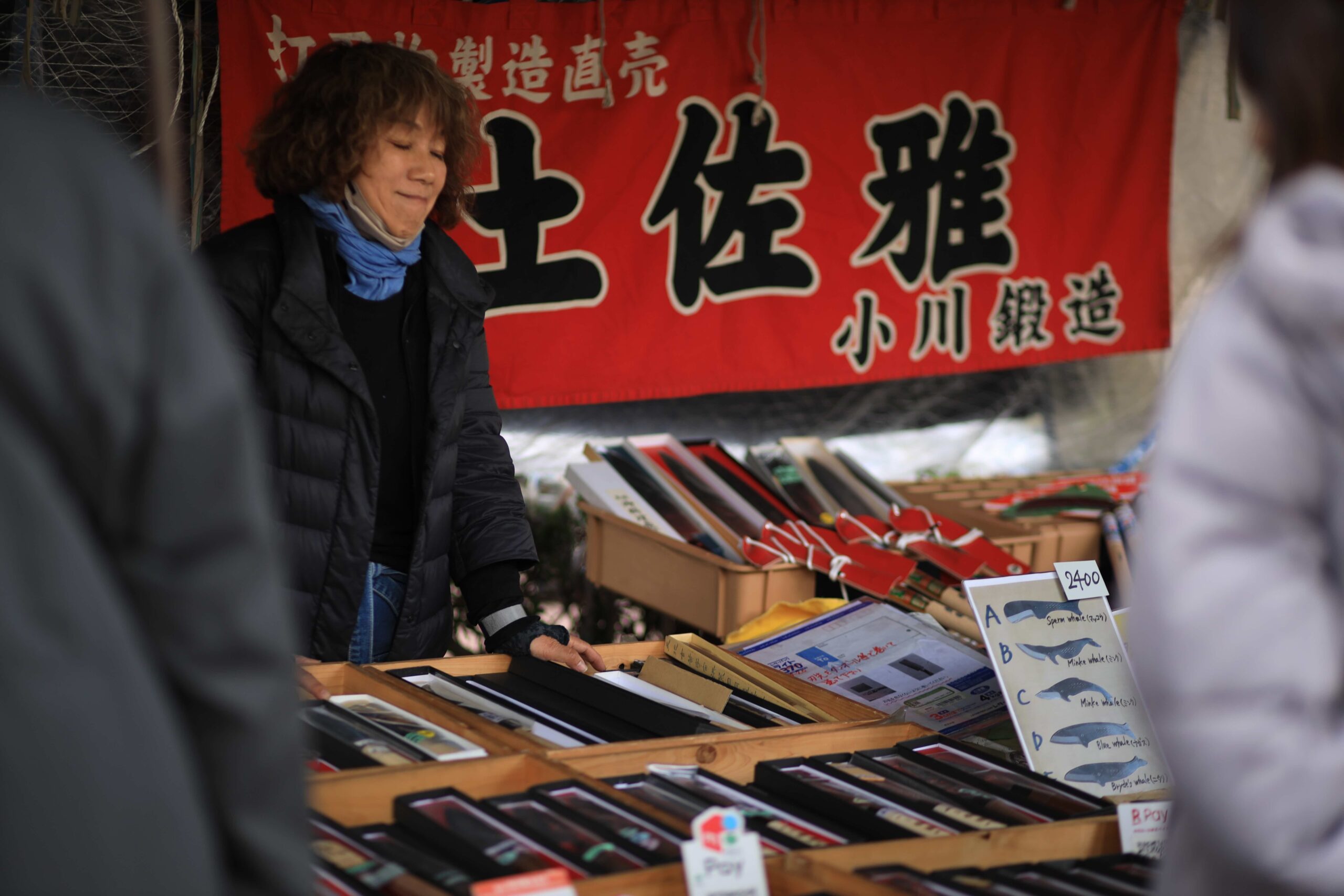 Vegetable vendor handing purchase to customer at Kochi Sunday Market