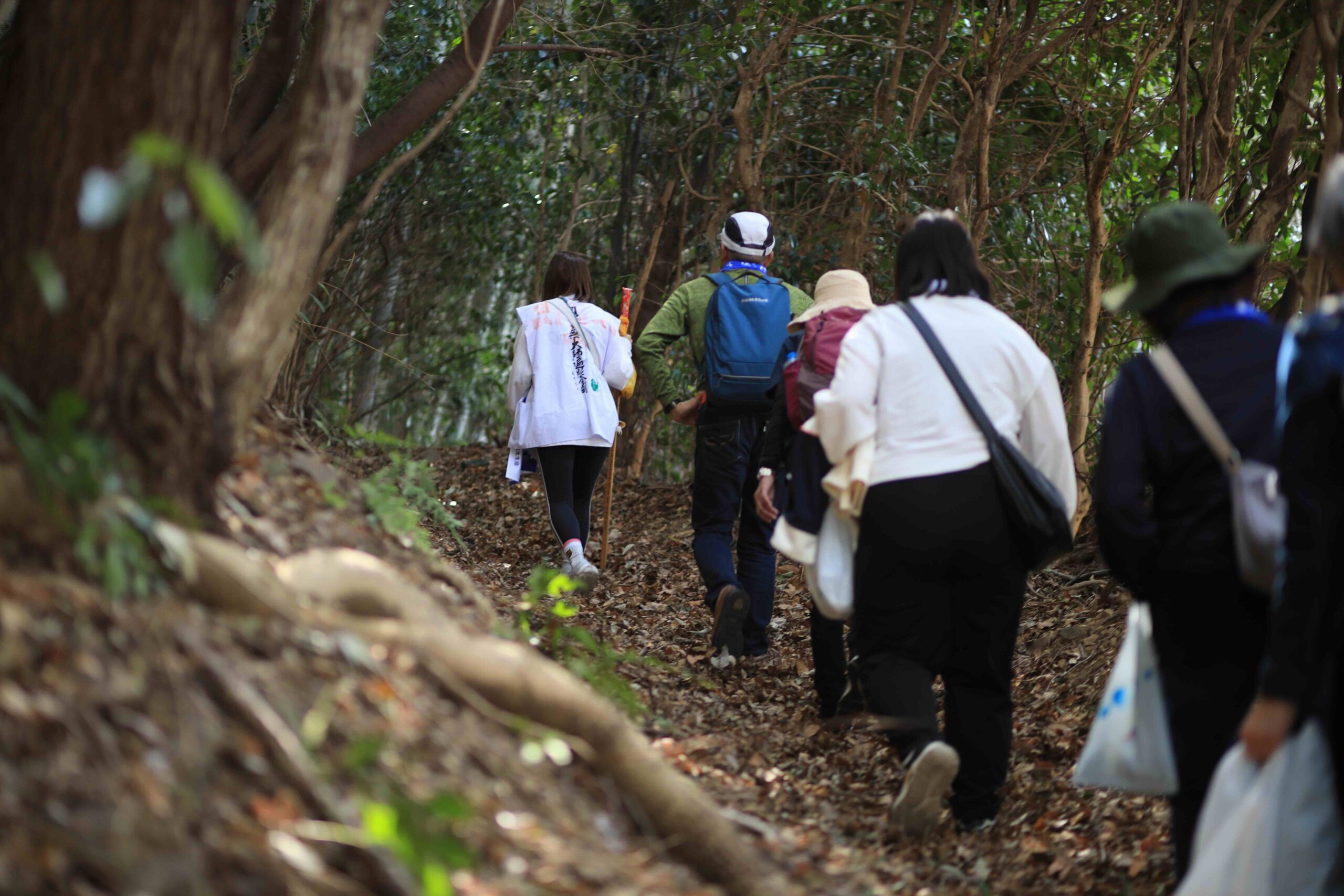 Pilgrim placing incense sticks at the stone urn at Zenjibuji Temple main hall