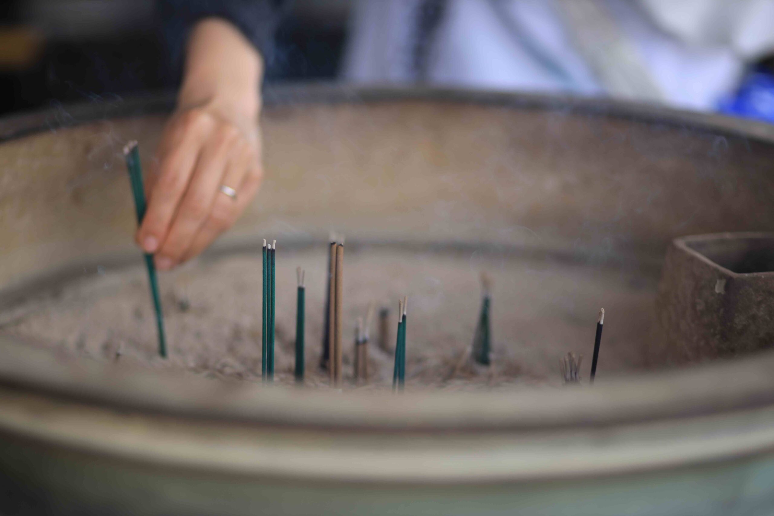 Stone Jizo statues with red bibs overlooking misty Tosa Bay at Zenjibuji Temple