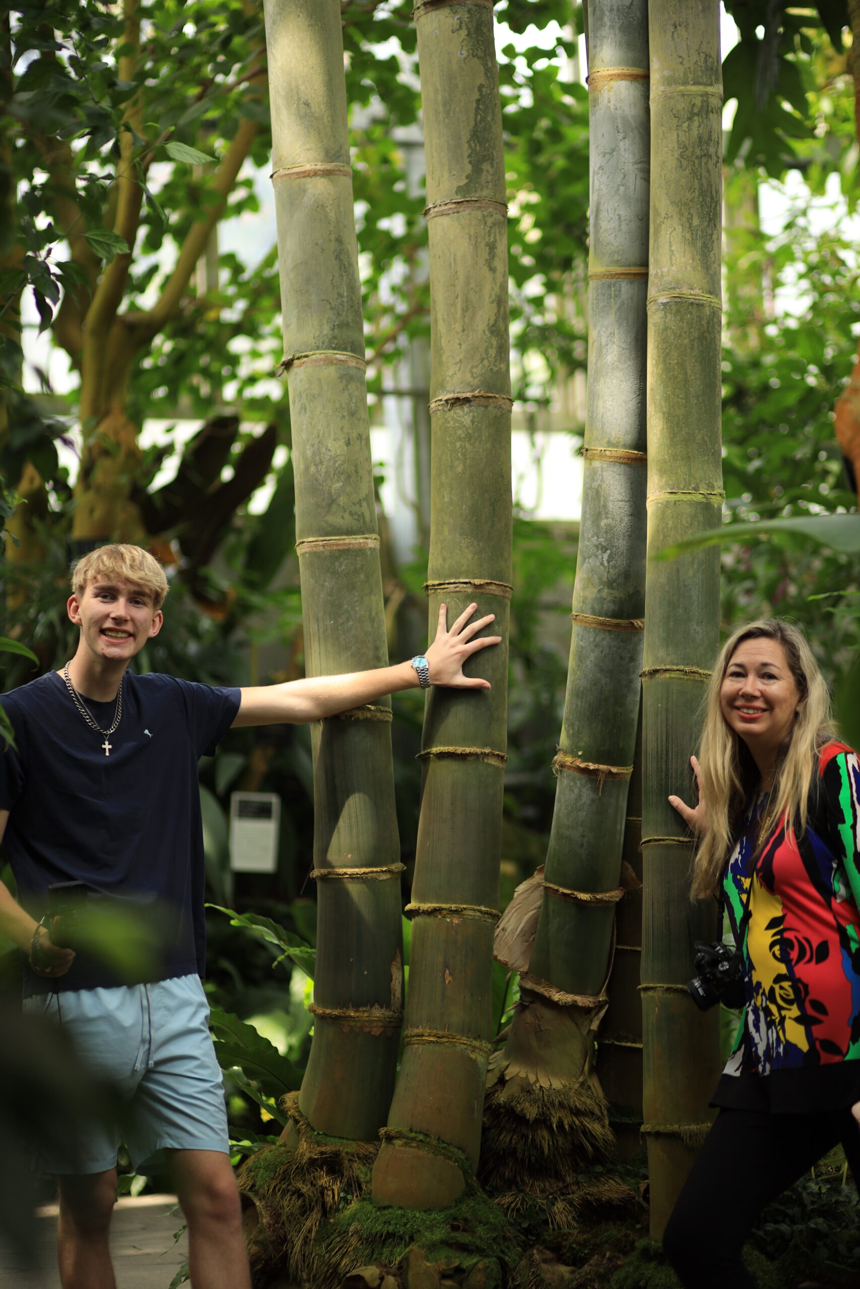 Mother and son exploring giant bamboo grove