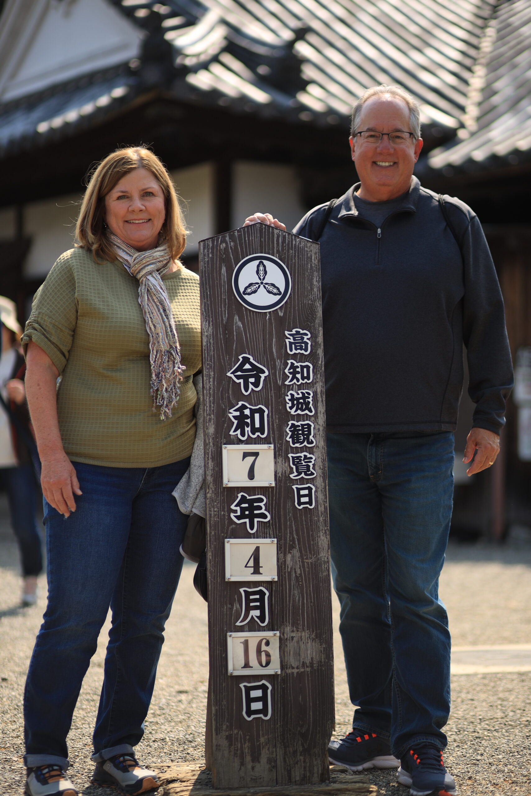 Couple posing with date sign at castle