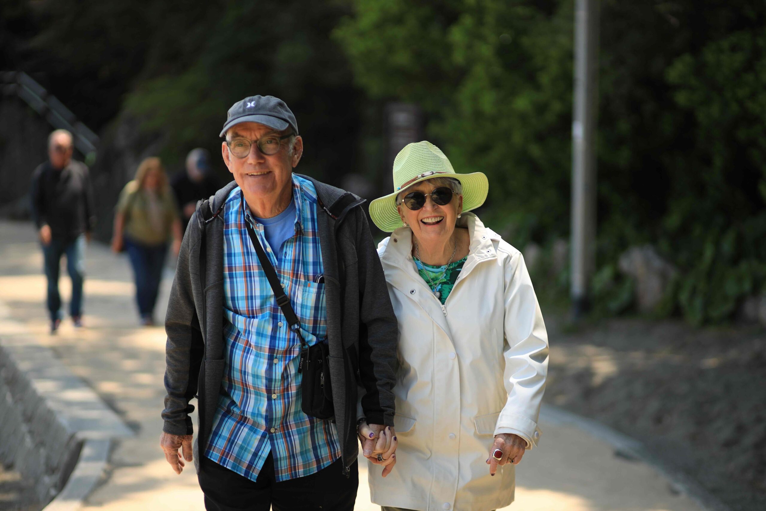 Couple walking hand in hand along the path at Katsurahama Beach Kochi