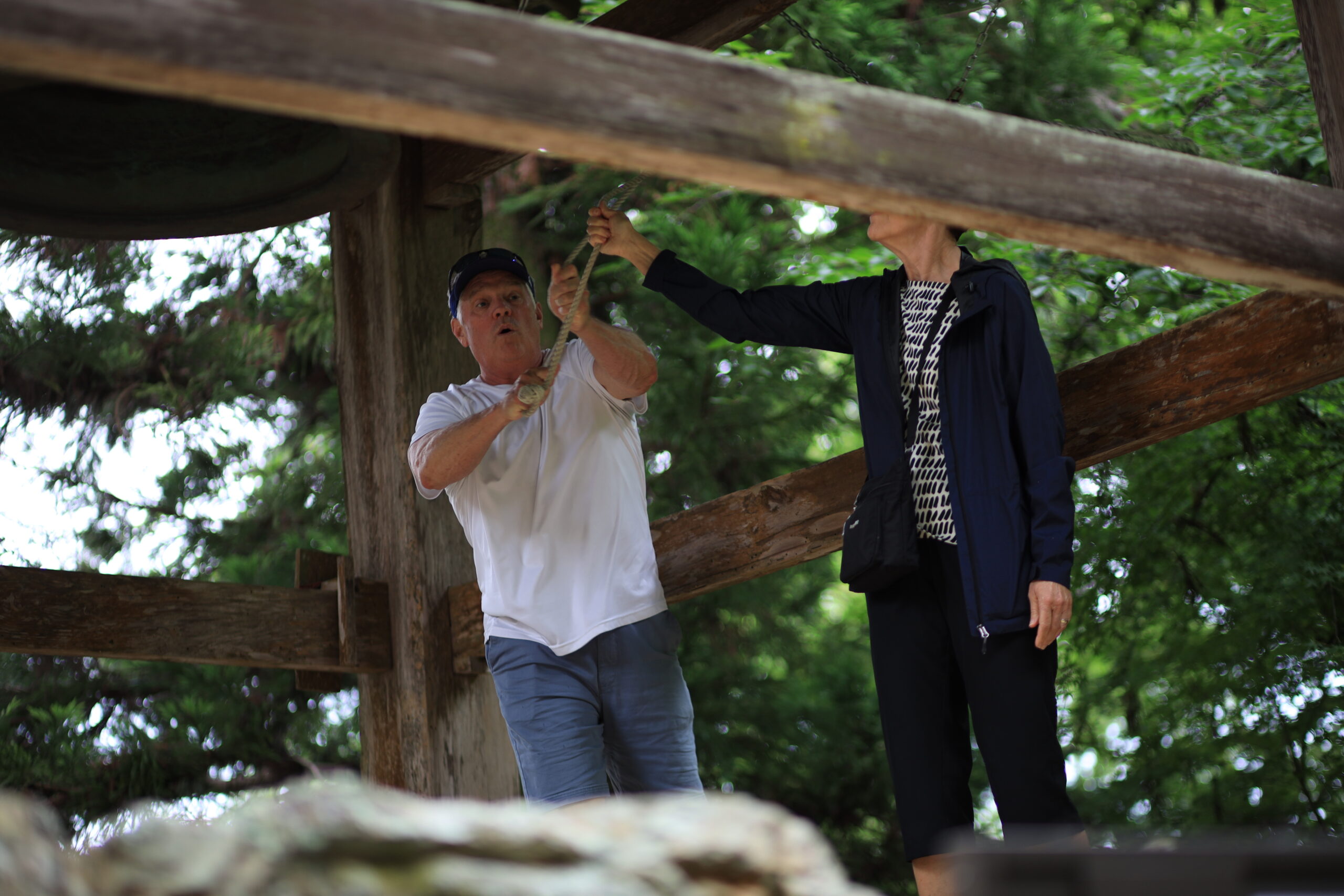 Visitors ringing the traditional bell at Chikurinji Temple wooden bell tower