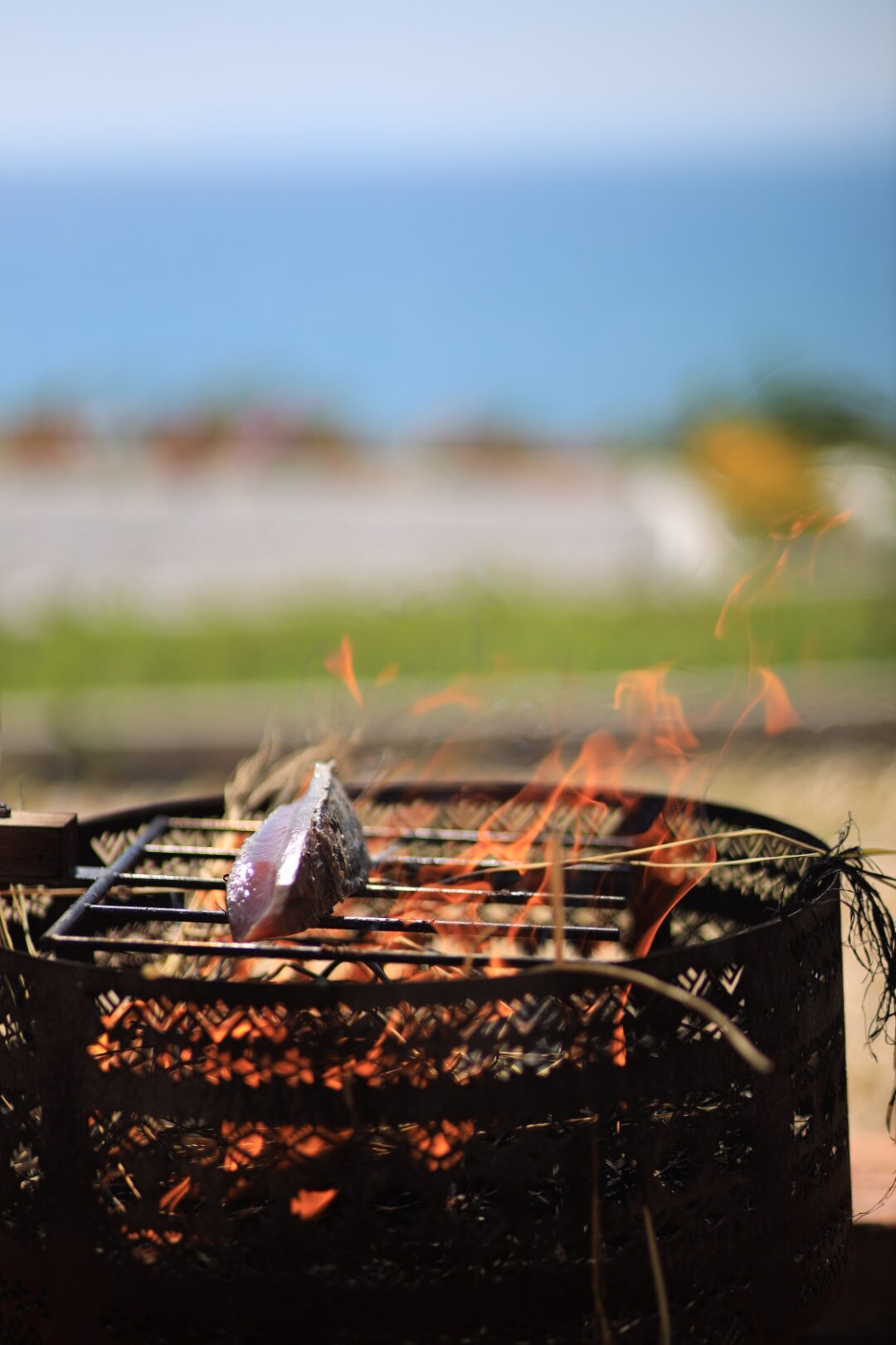 Bonito searing over traditional straw fire outdoors