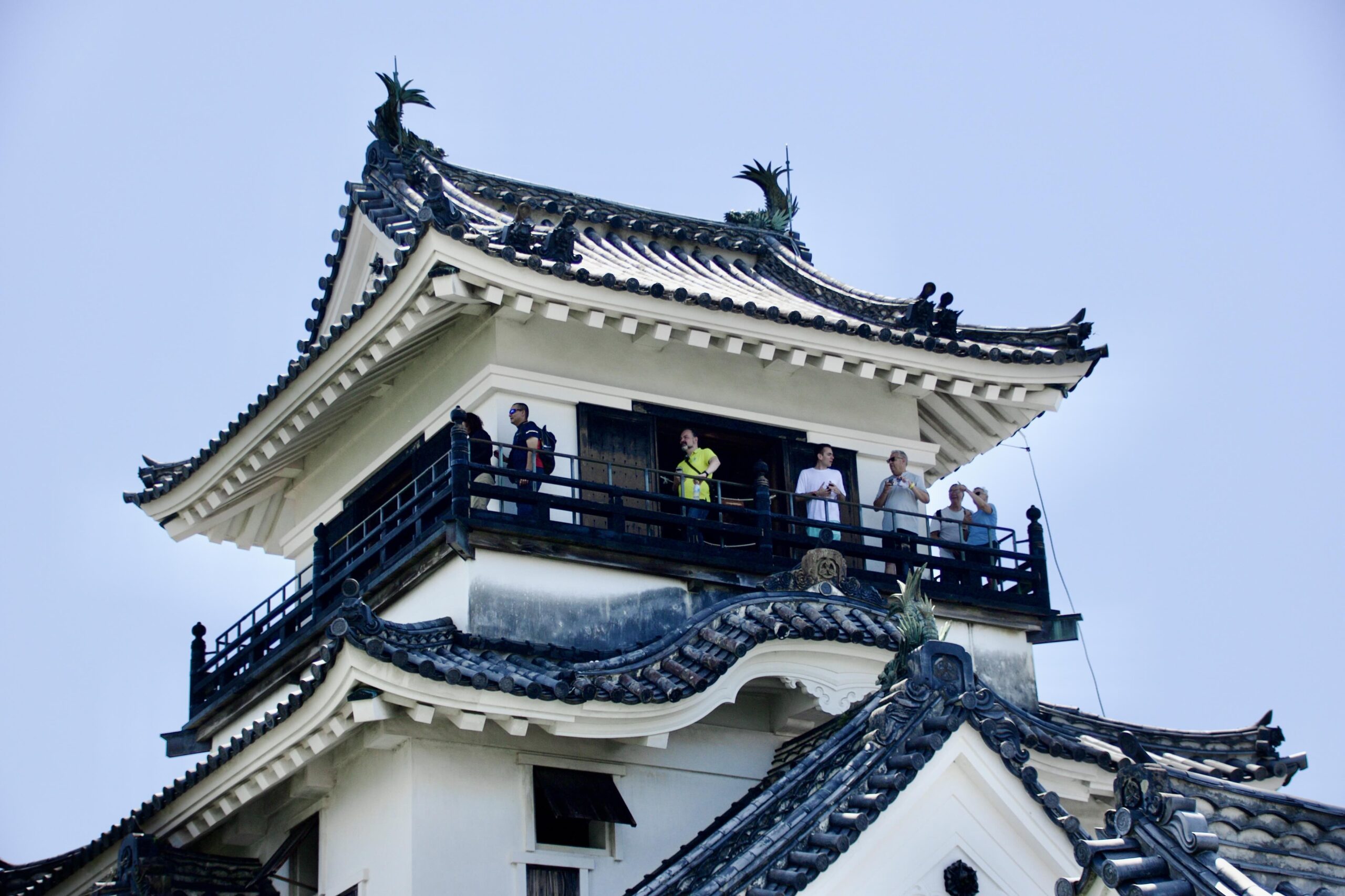 Visitors enjoying panoramic city view from castle balcony
