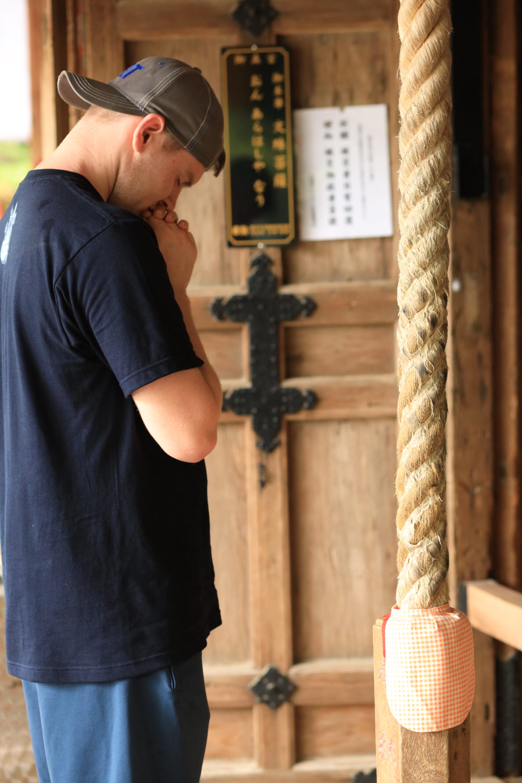 Tourist praying at traditional wooden temple door at Chikurinji Temple