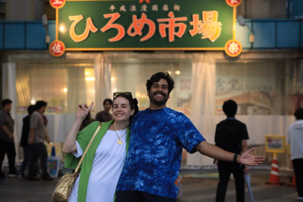 Guests in front of Hirome Market sign