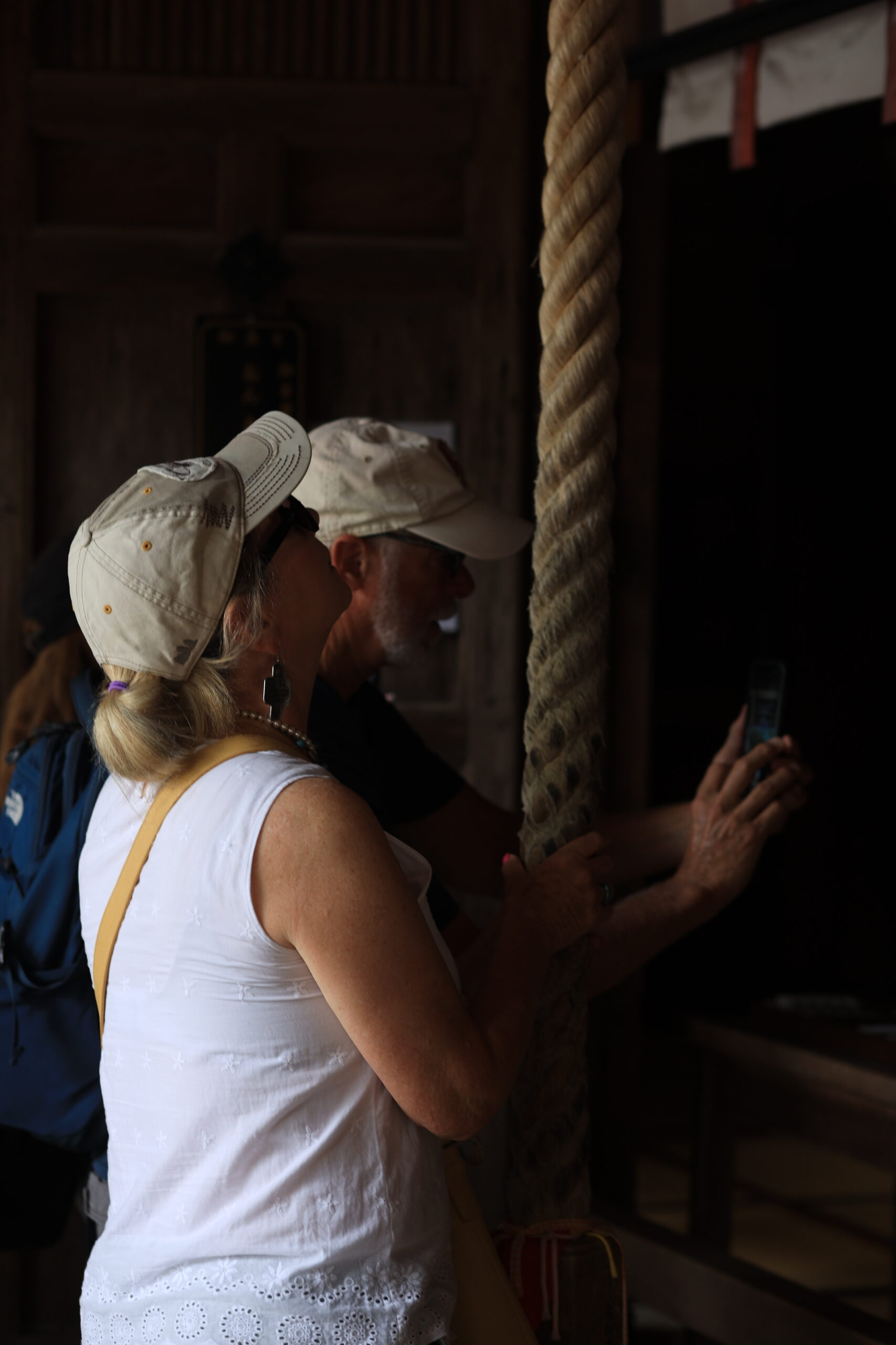 Touching the ancient temple bell rope