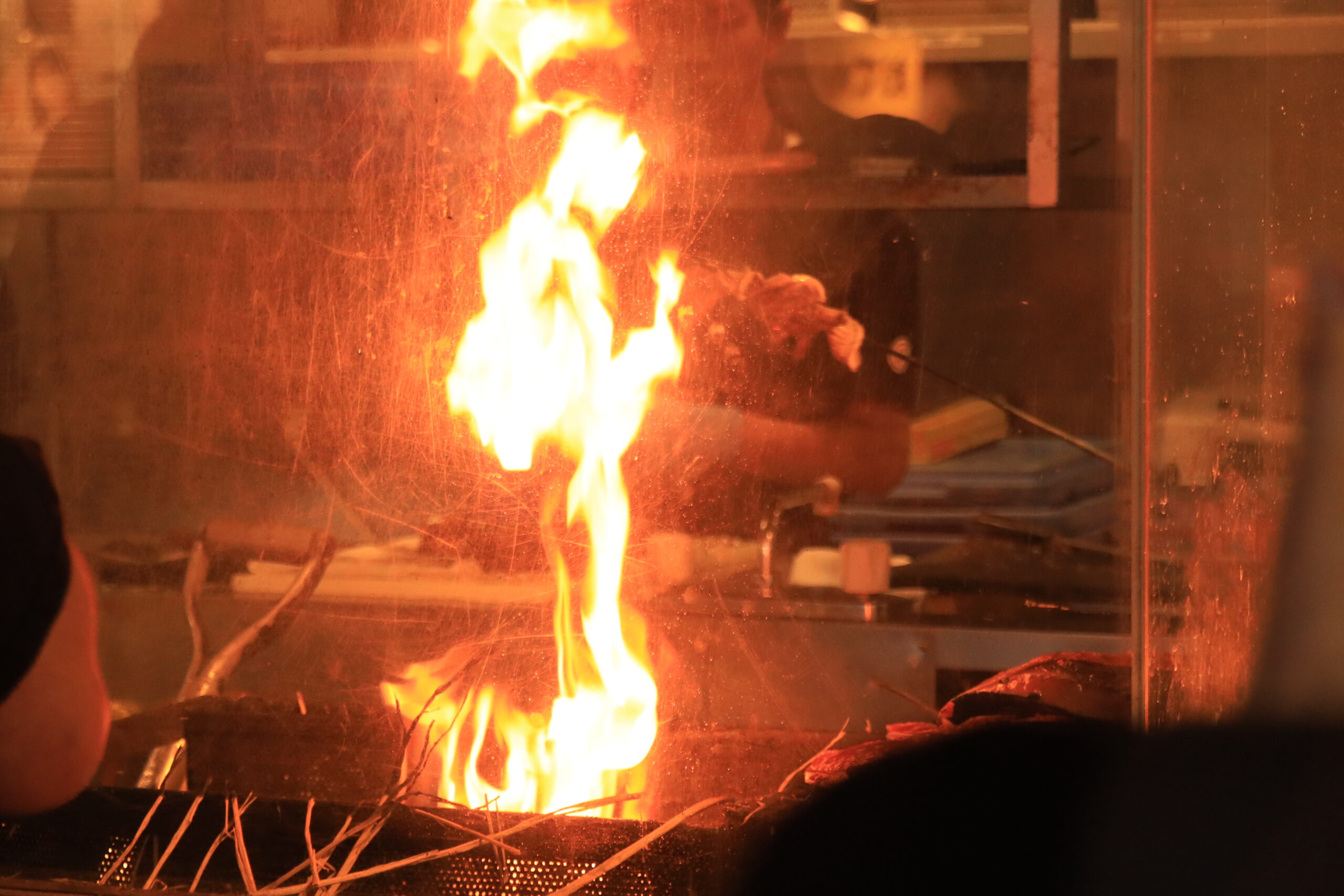 Fresh bonito being seared over intense flames