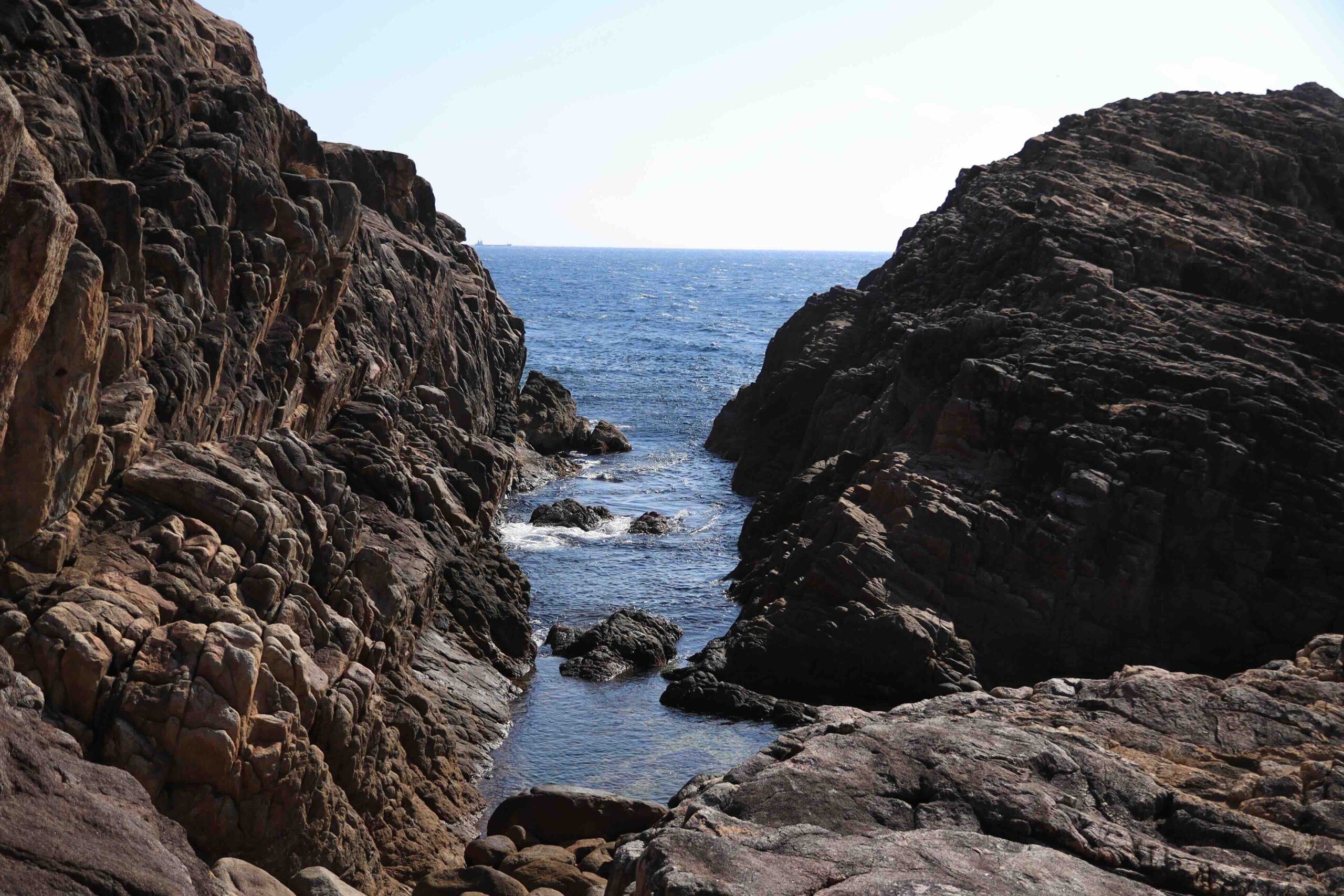 Stone path leading toward the rocky peak with the torii gate visible in the distance