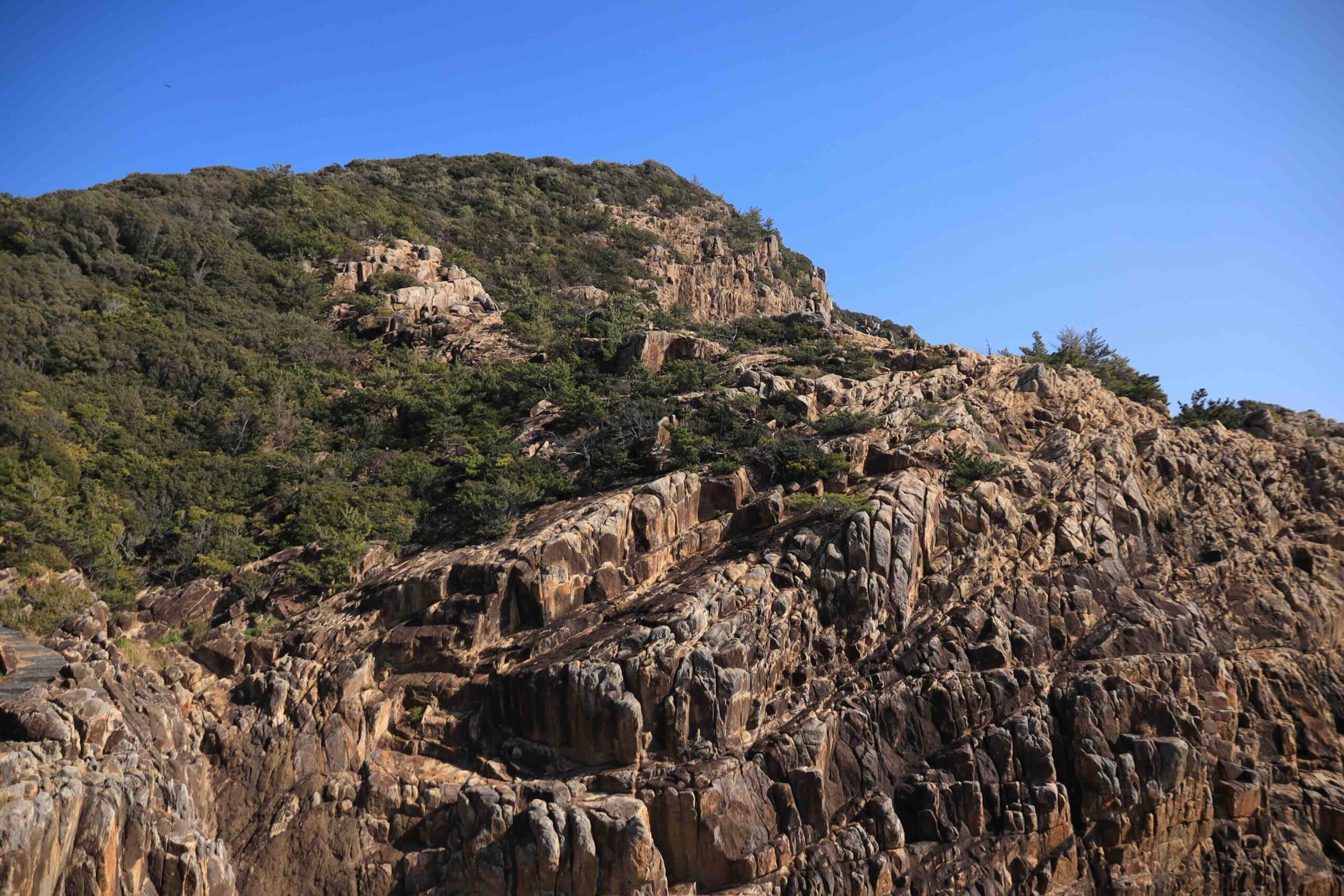 Narrow channel between rocky cliffs with the ocean visible beyond at Cape Ashizuri