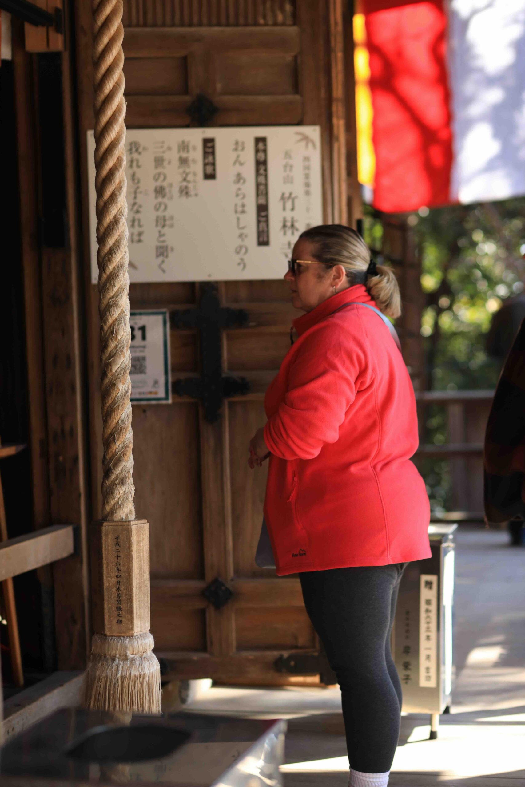 Guest reading temple sutra board at Chikurin-ji Temple entrance