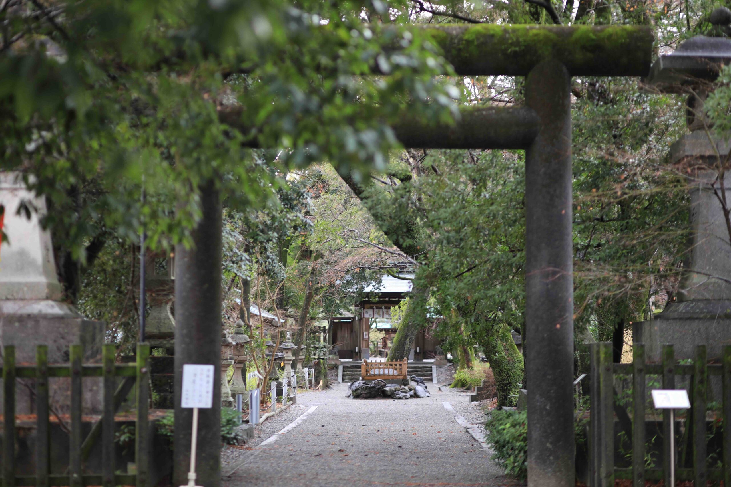 Stone torii gate and gravel path at the entrance of Yamauchi Shrine in Kochi
