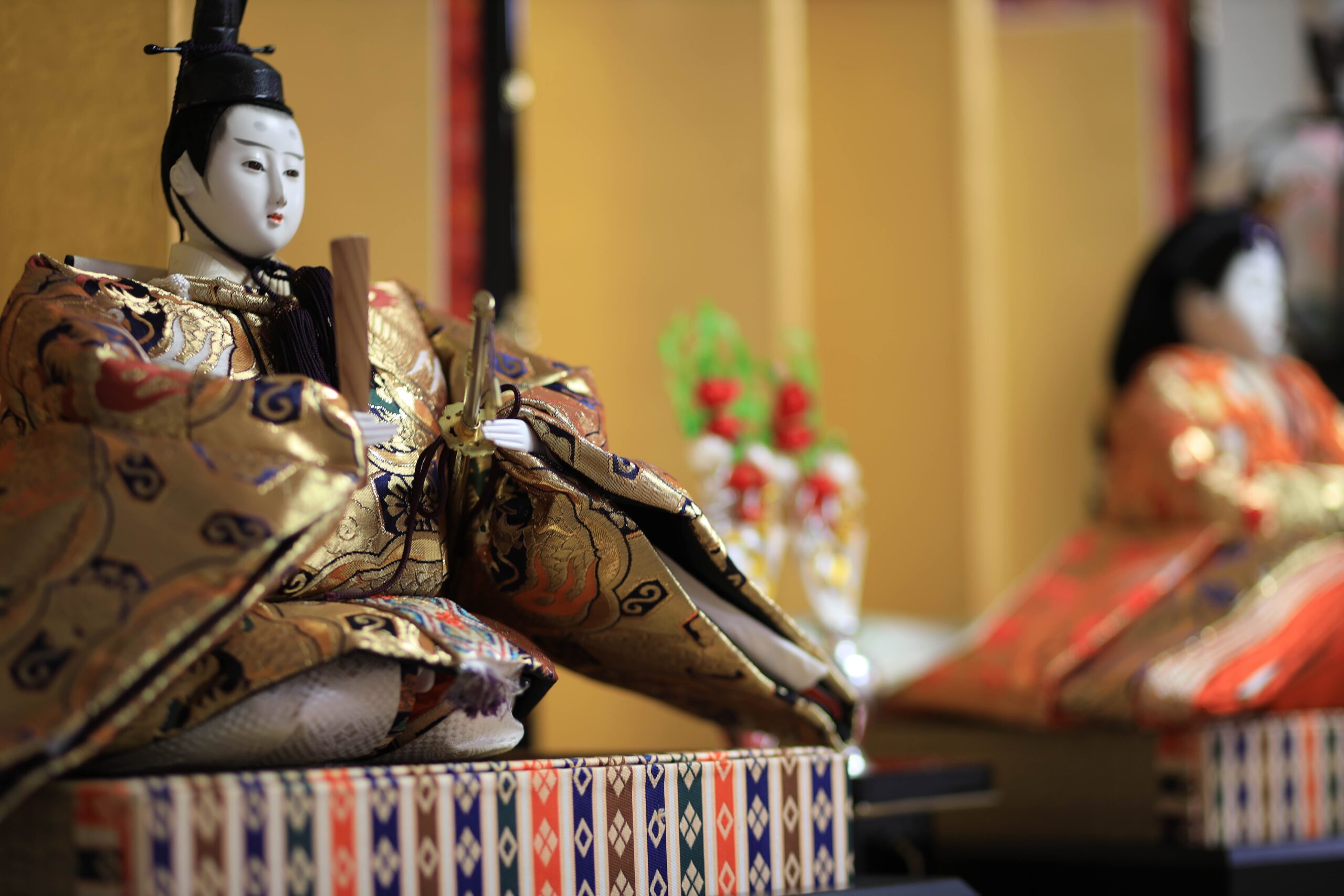 Close-up of the Dairi-sama male emperor doll in gold brocade kimono