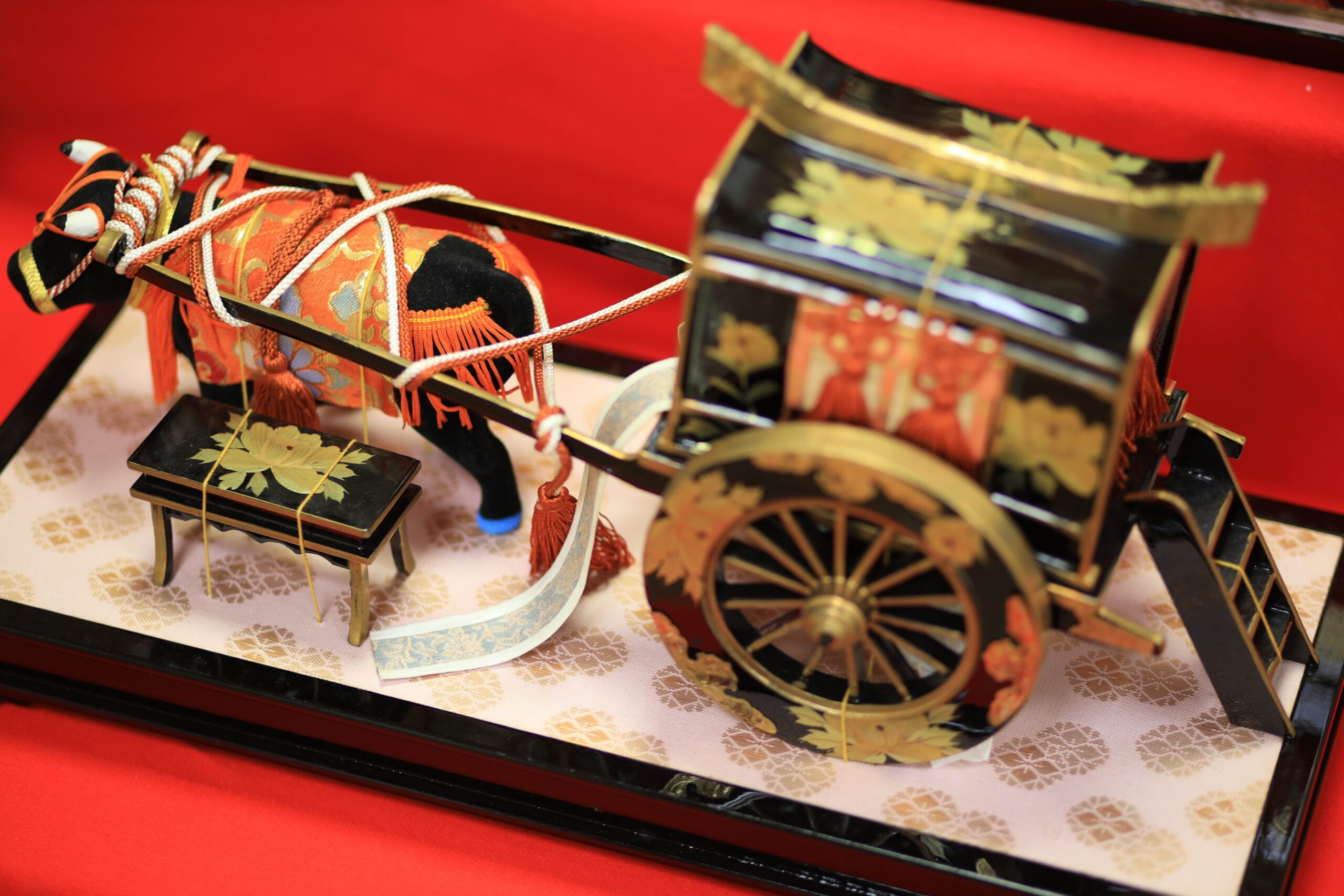 Miniature lacquered ox cart (gissha) with decorative ox, part of the Hina doll accessories