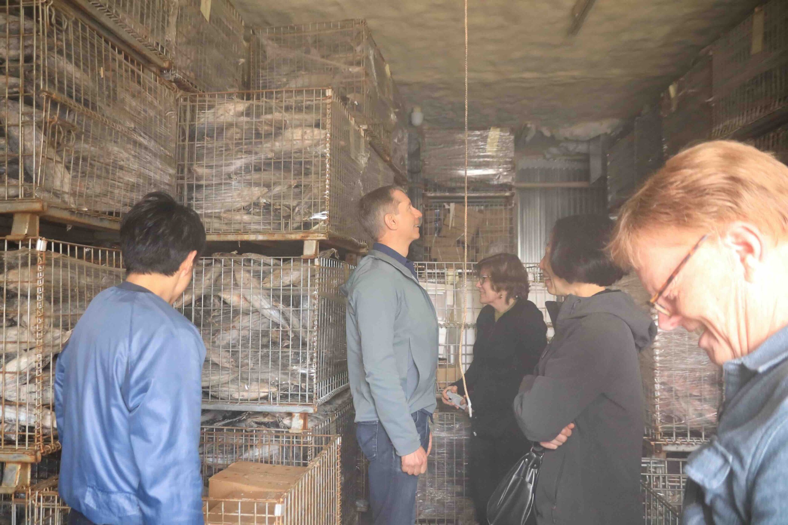 Visitors inside the Hamayoshiya aging and storage room
