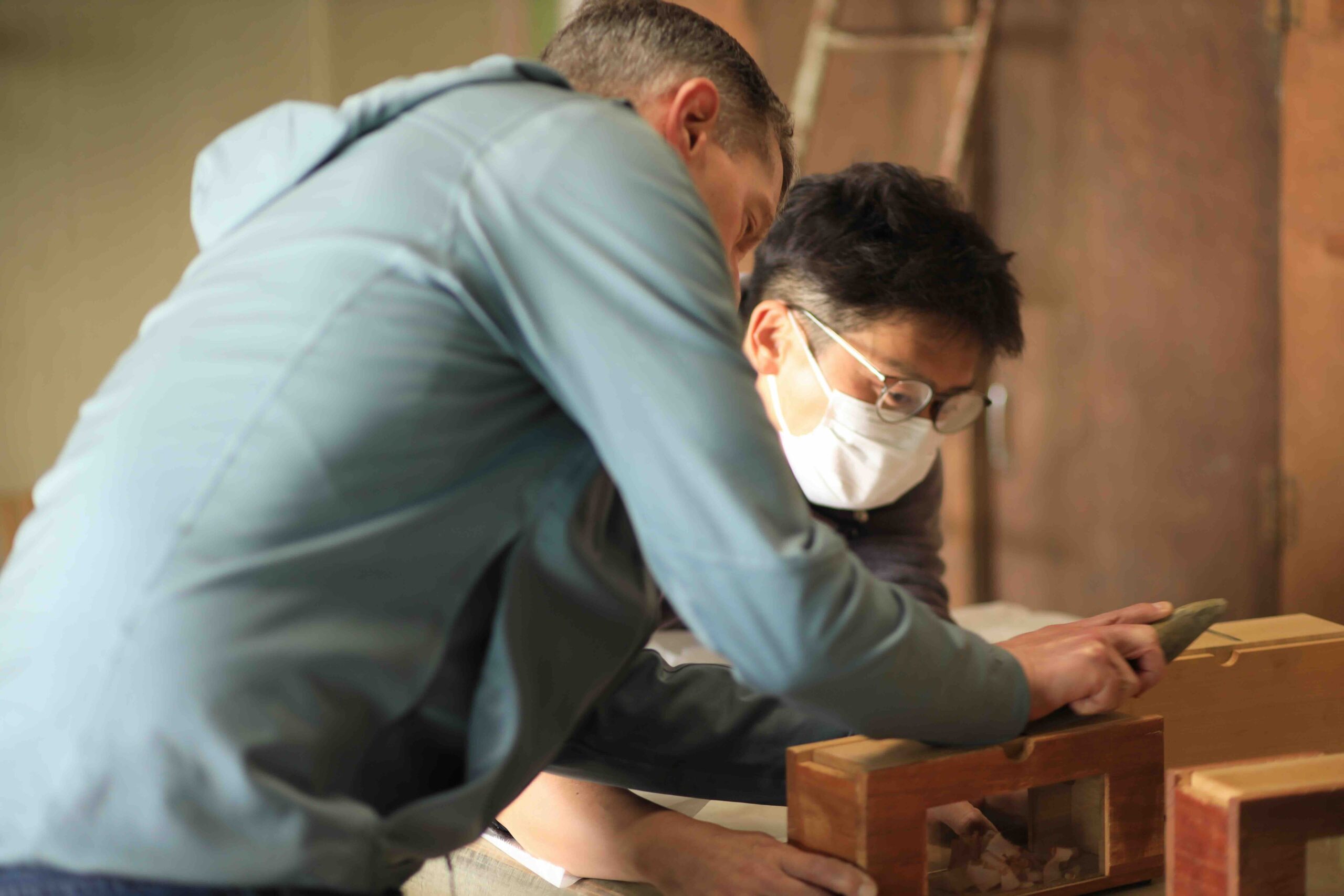 Guest trying to shave dried bonito at Takeuchi Shoten
