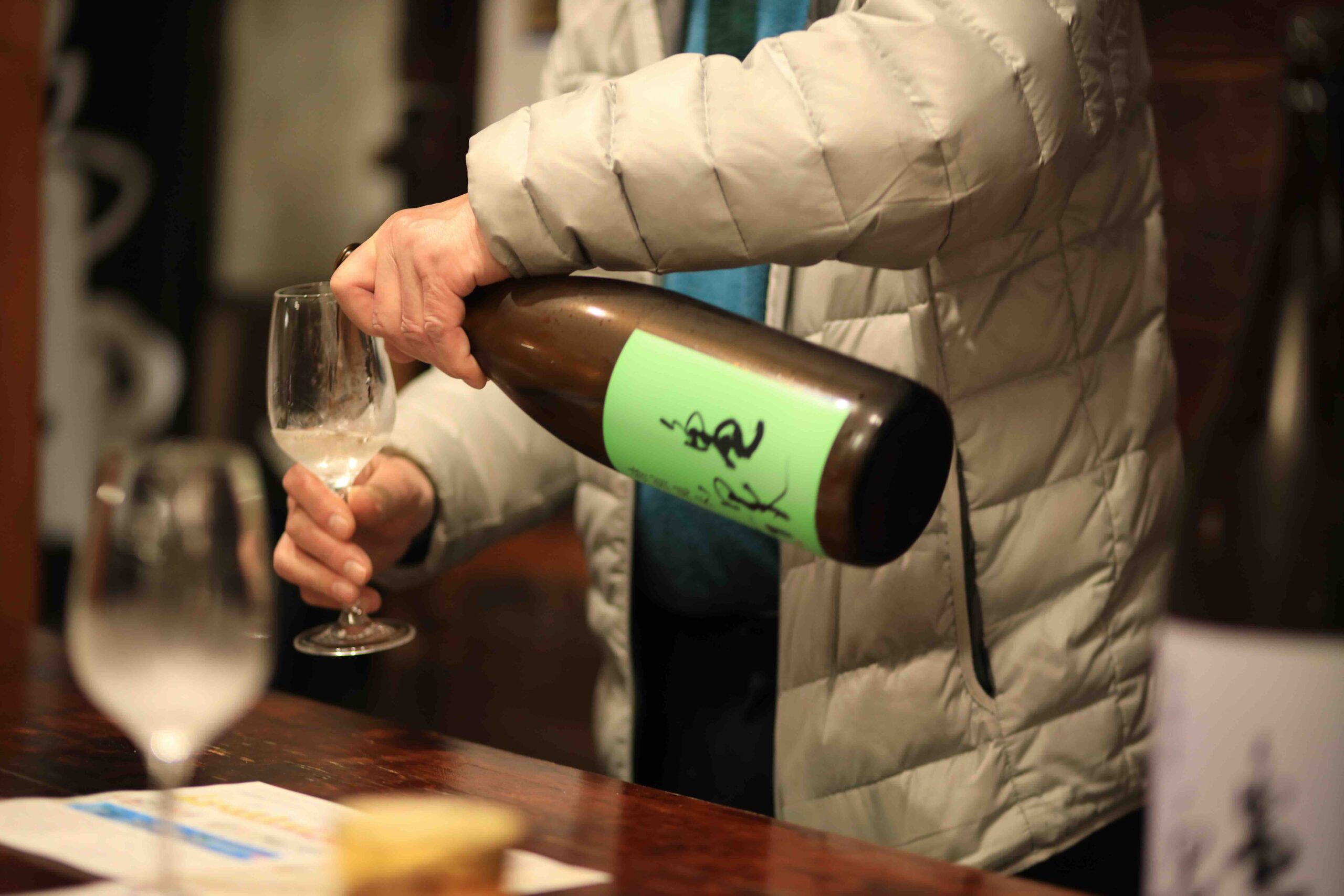 Sake being poured at Kameizumi Brewery