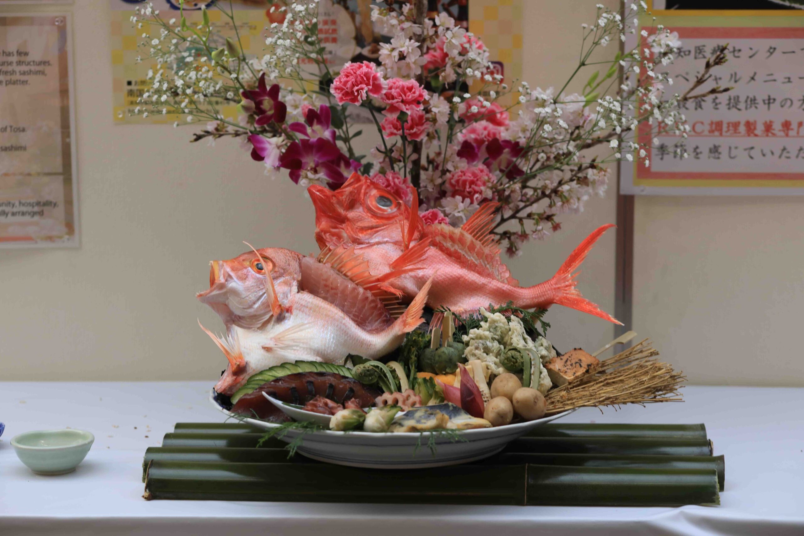Sawachi platter with two large red-scaled fish decorated with pink flowers and bamboo