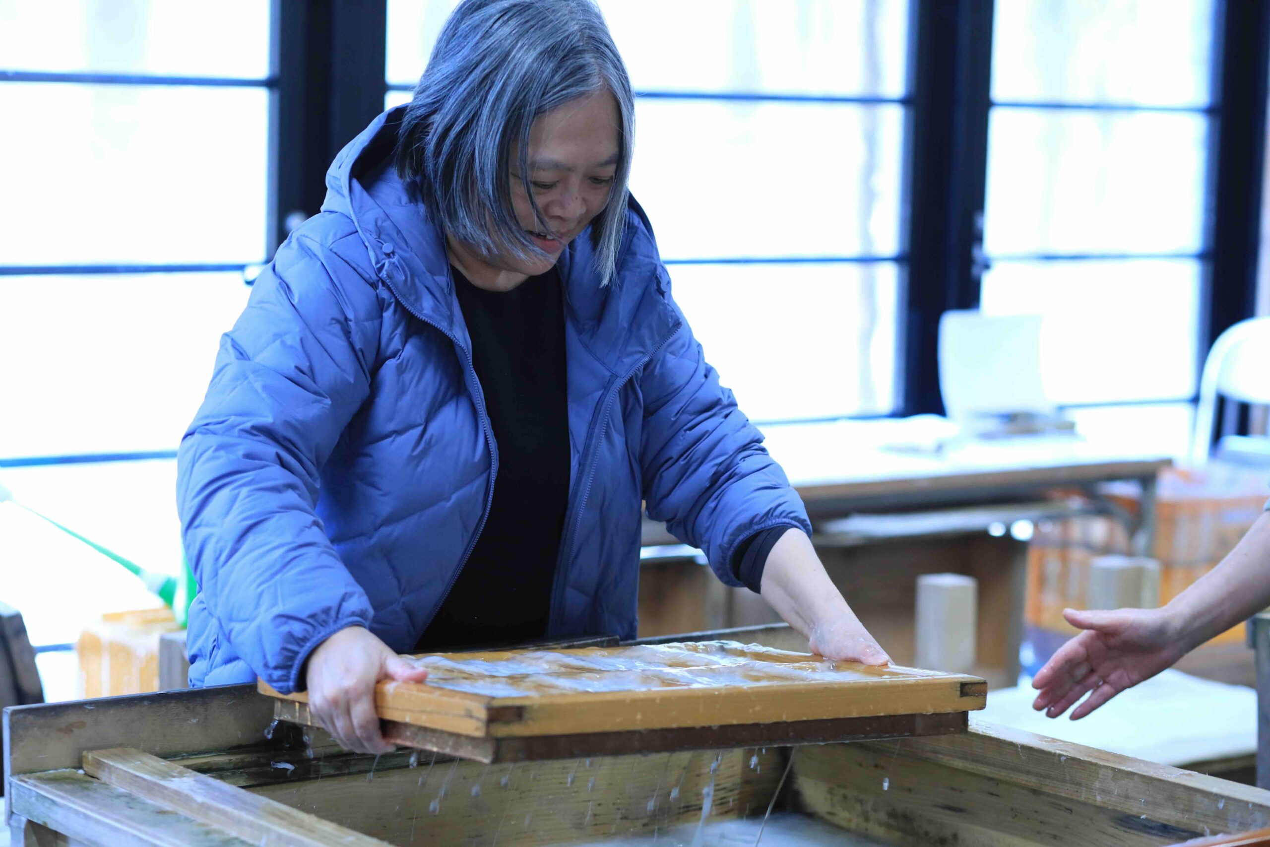Guest trying washi papermaking at Kami no Hakubutsukan Paper Museum in Kochi