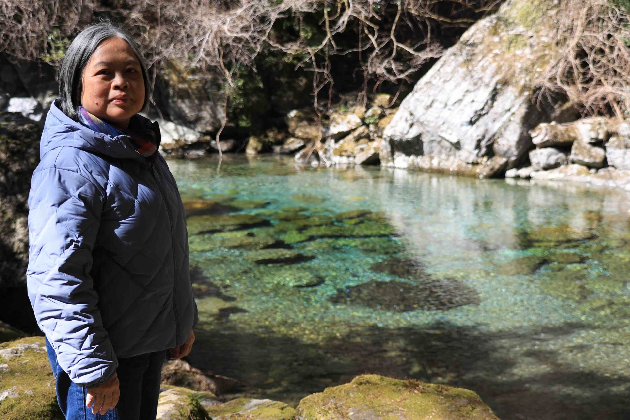 Guest standing beside the Niyodo Blue crystal pool in Kochi