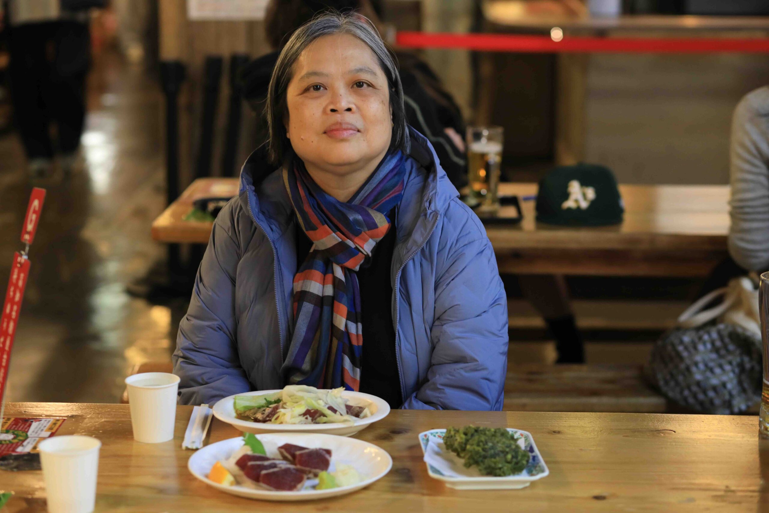 Guest enjoying katsuo no tataki and food at Hirome Ichiba market in Kochi