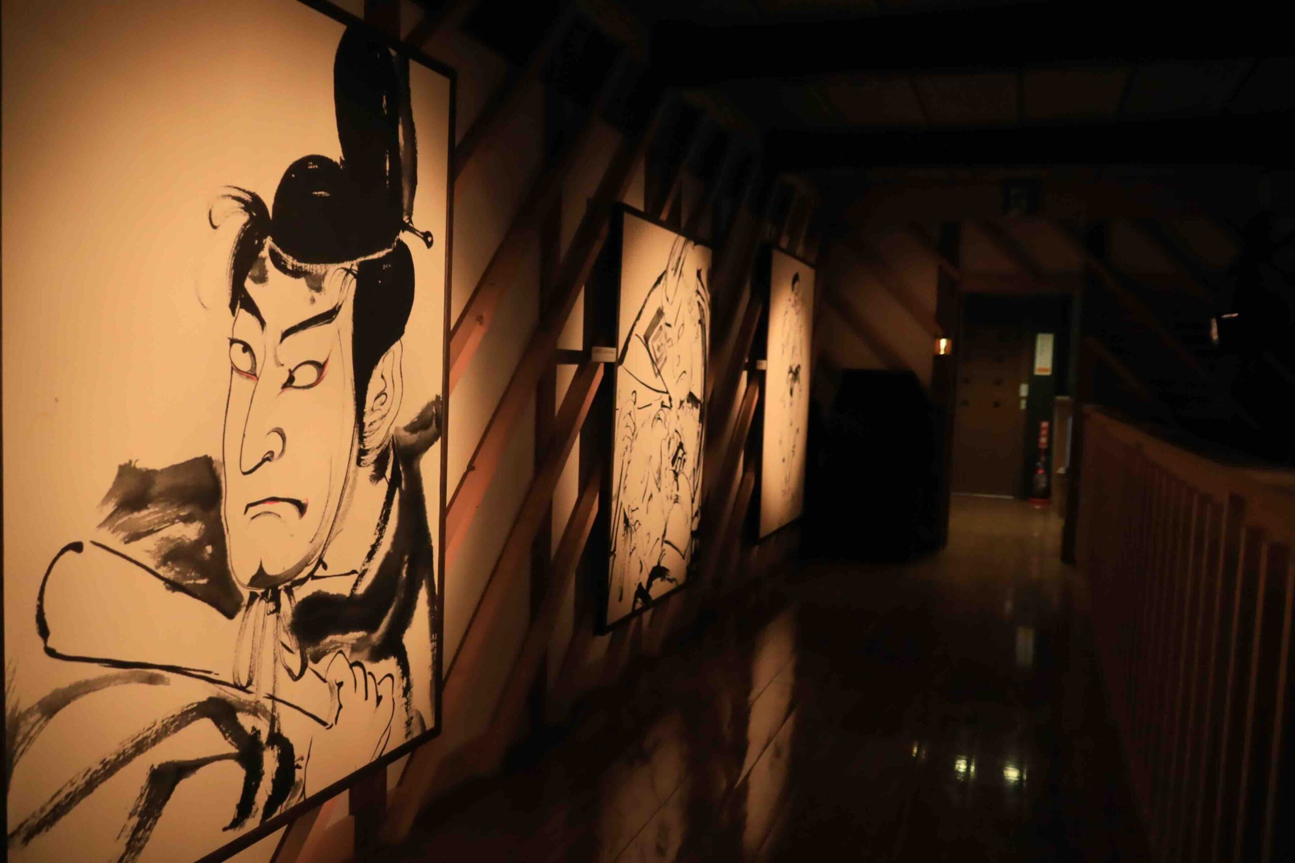 Gallery corridor in the Ekin-Gura museum displaying dramatic ink brush portraits of kabuki actors