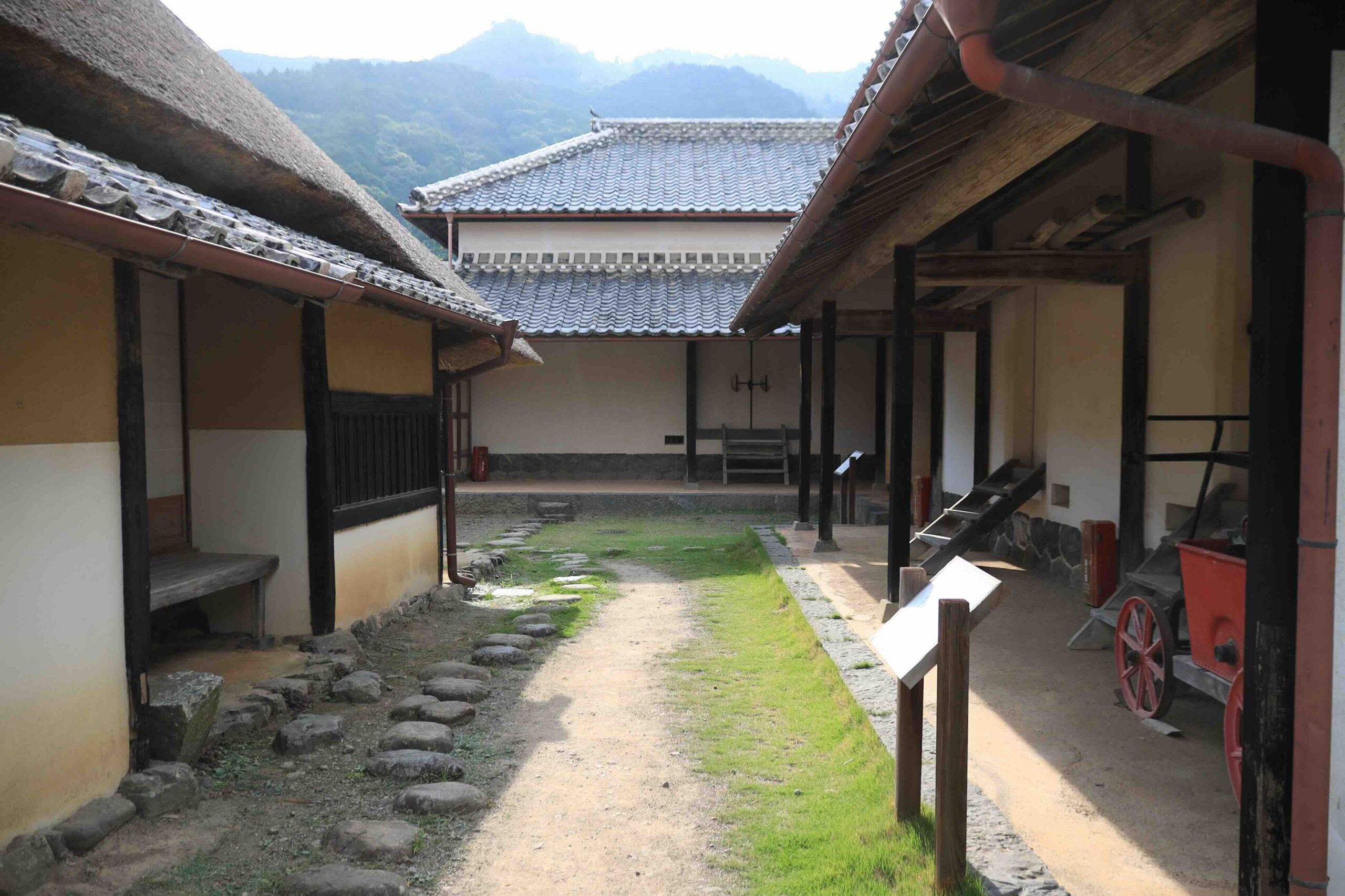 Inner courtyard of the Iwasaki Yataro birthplace complex with multiple traditional buildings in Aki City Kochi