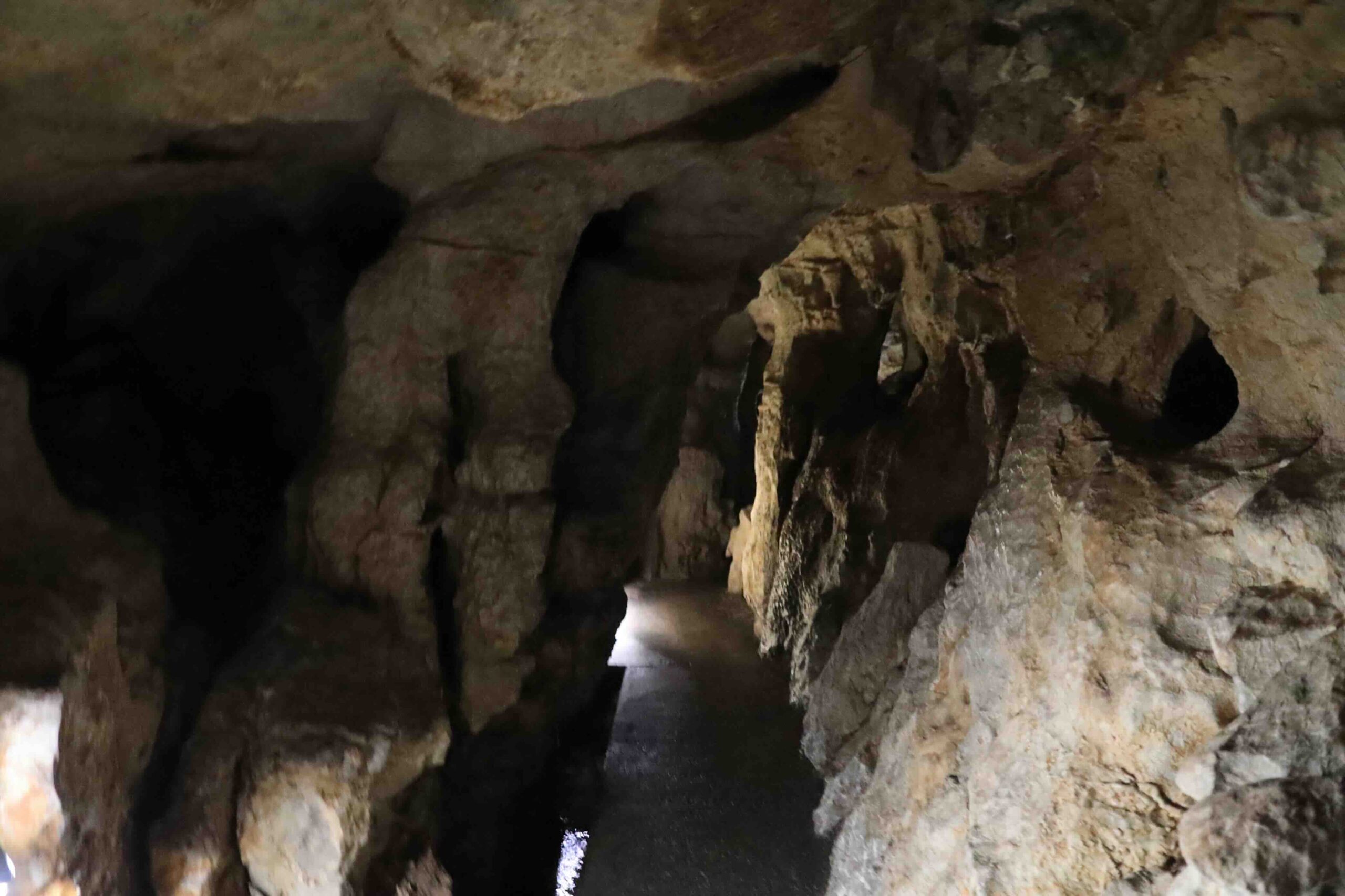 Natural rock corridor inside Ryugado cave with dramatic stone formations in Kochi