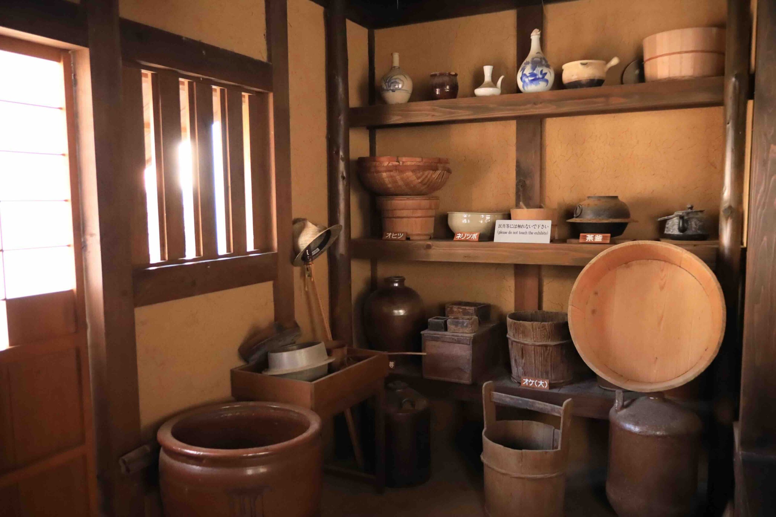 Kitchen utensils and ceramic pottery displayed inside the restored Manjiro birthplace in Kochi