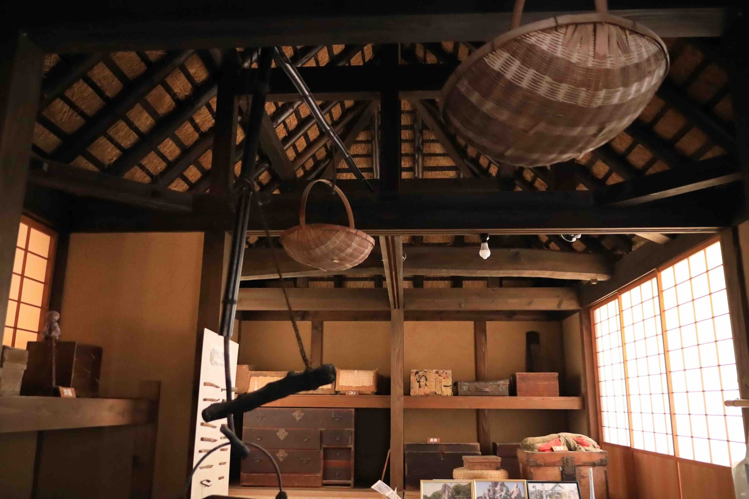 Old wooden storage chests and woven baskets inside the Manjiro birthplace farmhouse in Tosashimizu Kochi