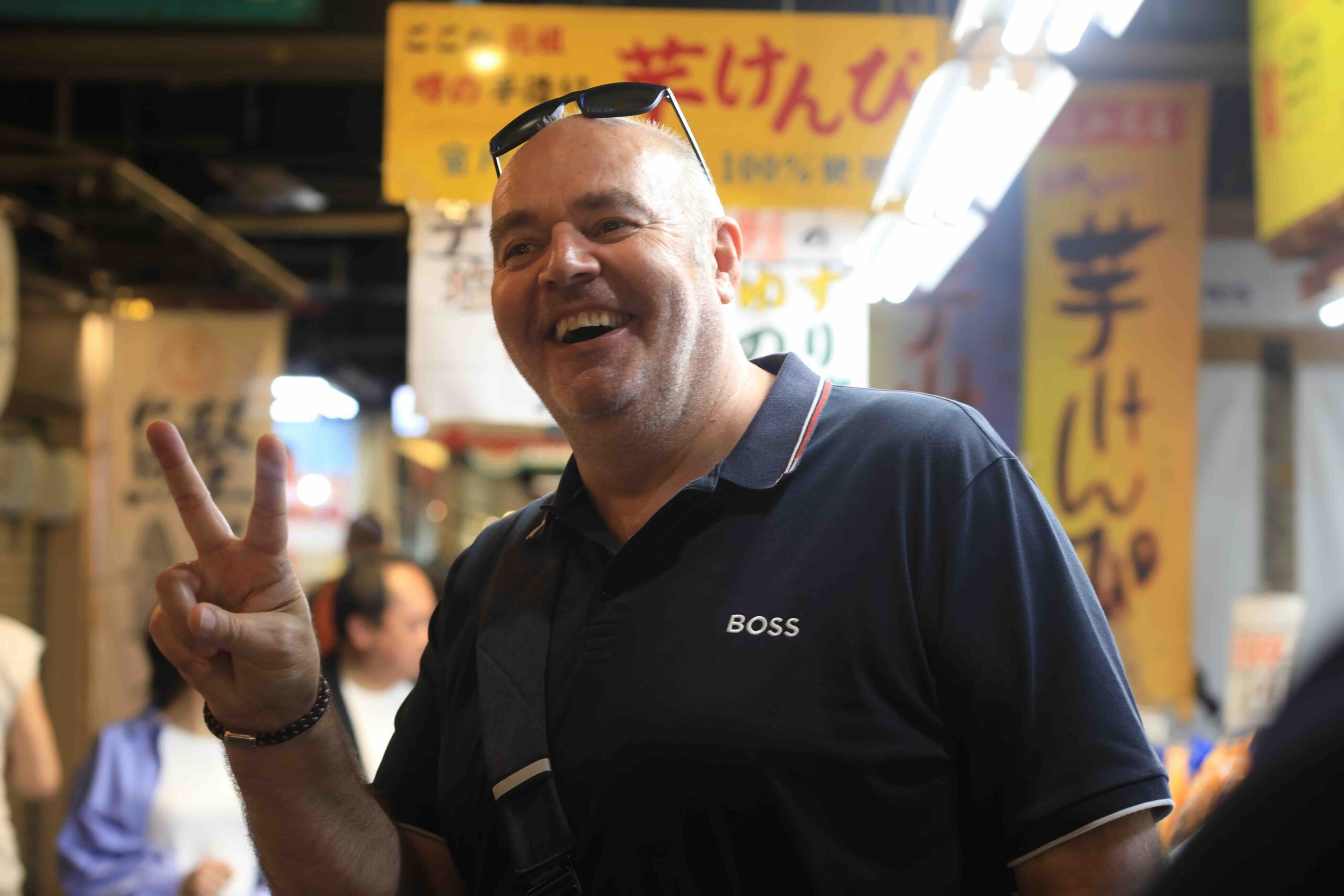 A happy guest enjoying the lively atmosphere of Hirome Market in Kochi