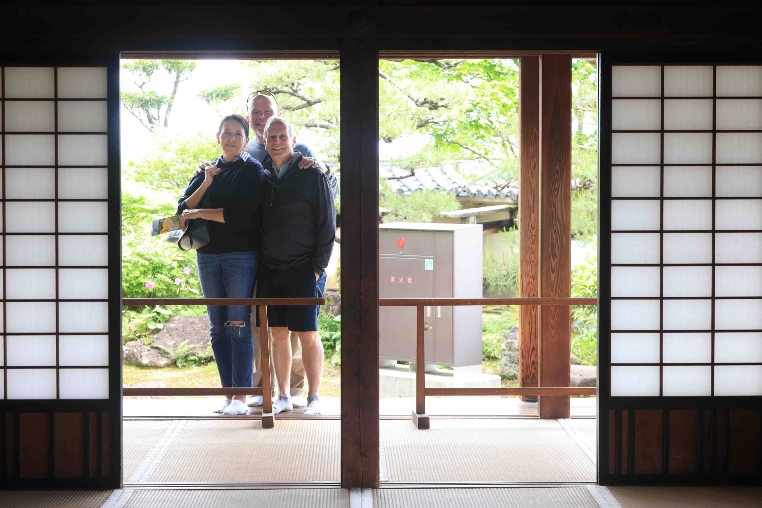 Guests framed by shoji screens at Okawasuji Samurai Residences