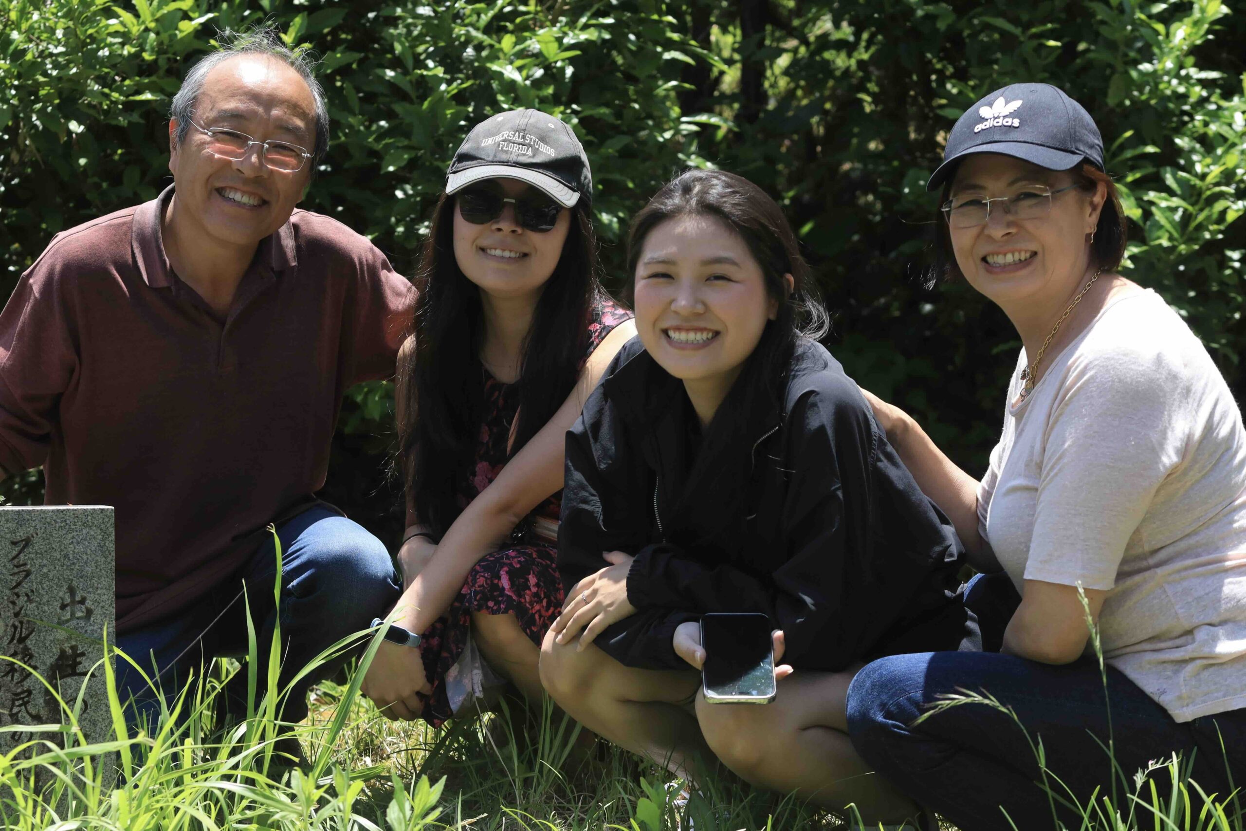 Brazilian Japanese family smiling together at ancestral grave in Tsuno-cho Kochi Japan